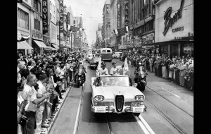 Spectators line Broadway as Dodgers manager Walter Alston, right, and coach Charlie Dressen ride in a caravan to their first game at the Coliseum.