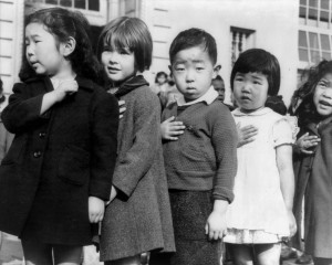 Japanese American children pledging allegiance to the flag. Photo by Dorothea Lange (March 1942).